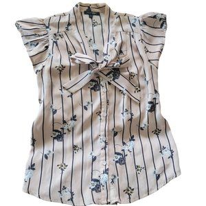 Beige blouse with white flowers. Size Small. Ribbon in the neck.